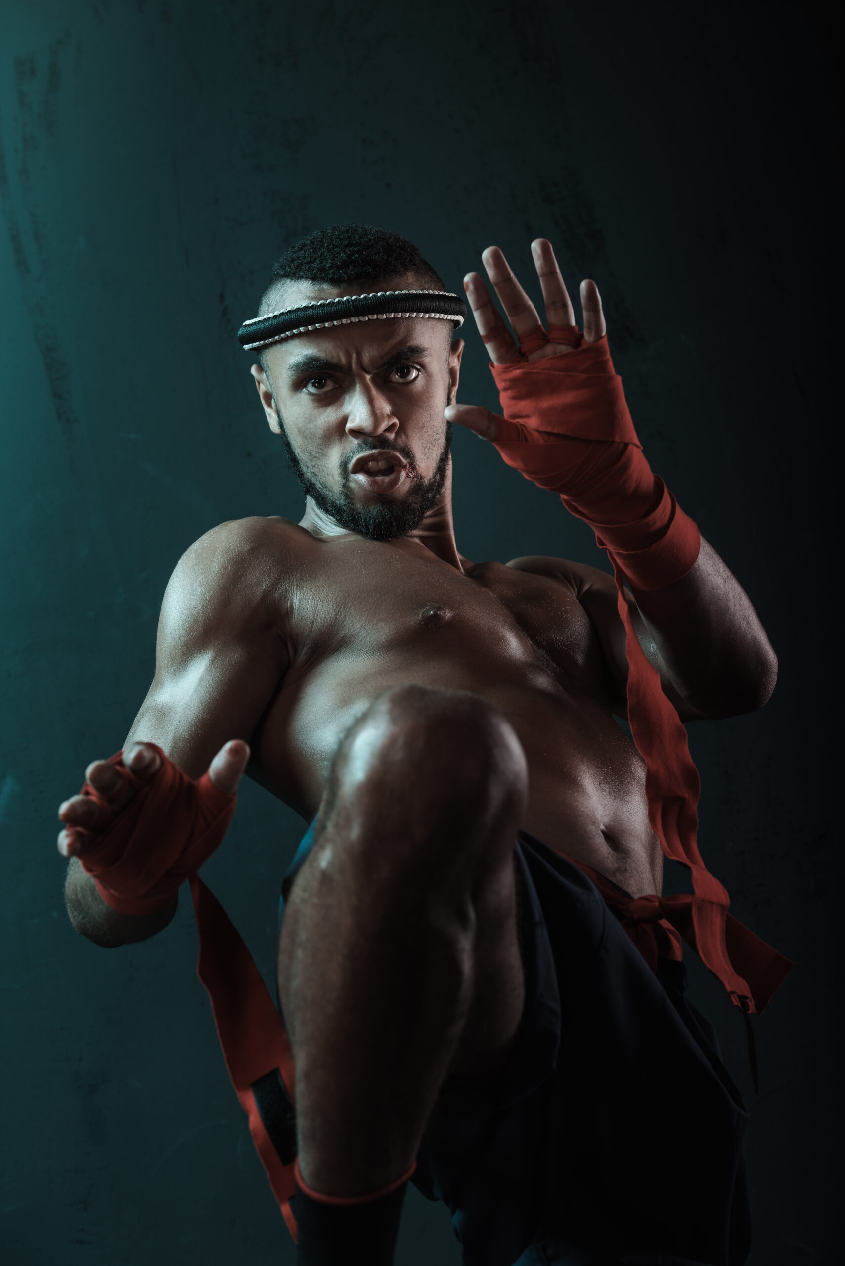 Low angle view of determined Muay thai fighter training thai boxing, action sport concept